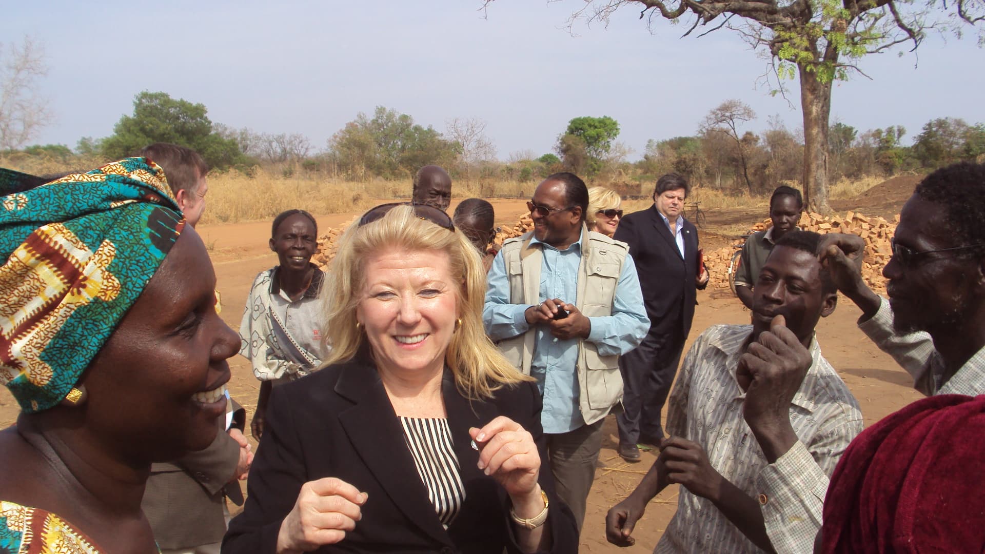 Community members greeting a member of the visiting delegation